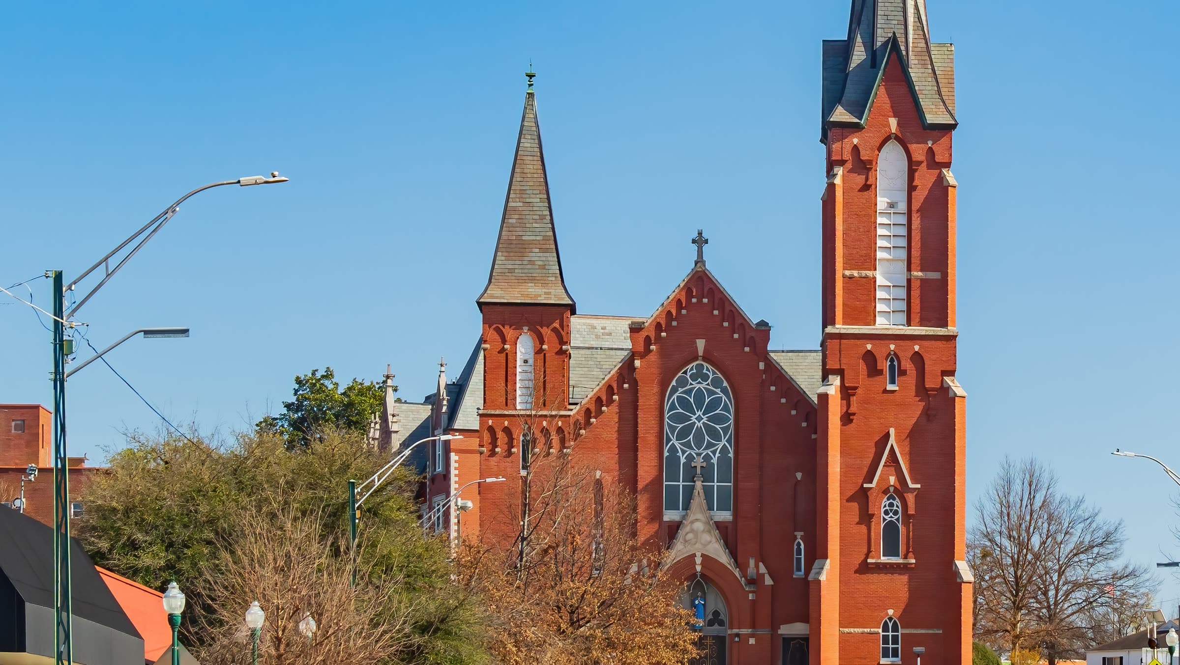 Immaculate Conception Church and its steeple on a downtown Fort Smith, Arkansas street