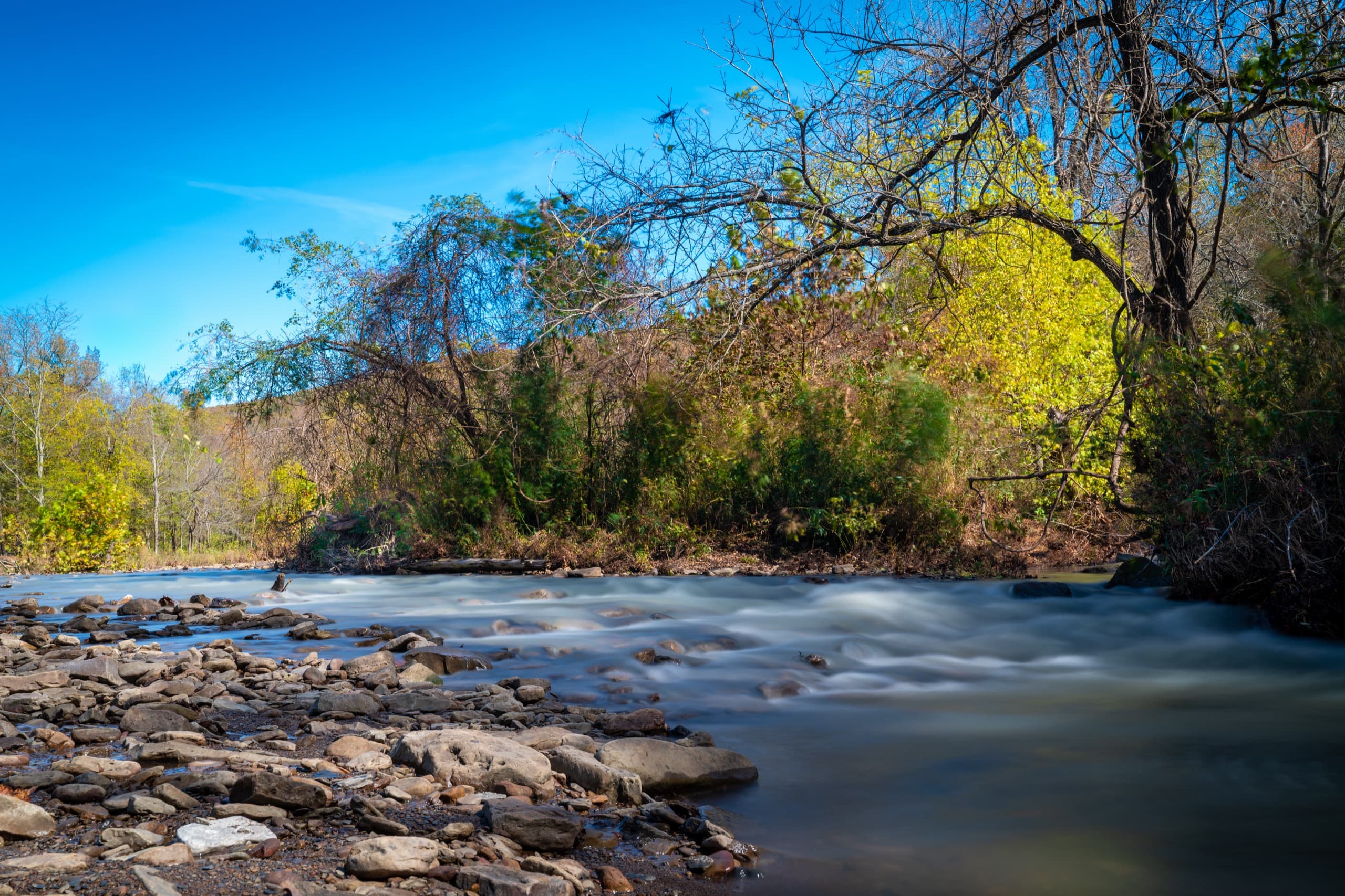 A creek flowing over rocks in Northwest Arkansas in autumn